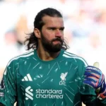 Liverpool Define Futuro No Gol: Alisson Permanece Até 2027 Enquanto Sucessão Com Mamardashvili E Promessa Brughmans Agita Bastidores De Anfield